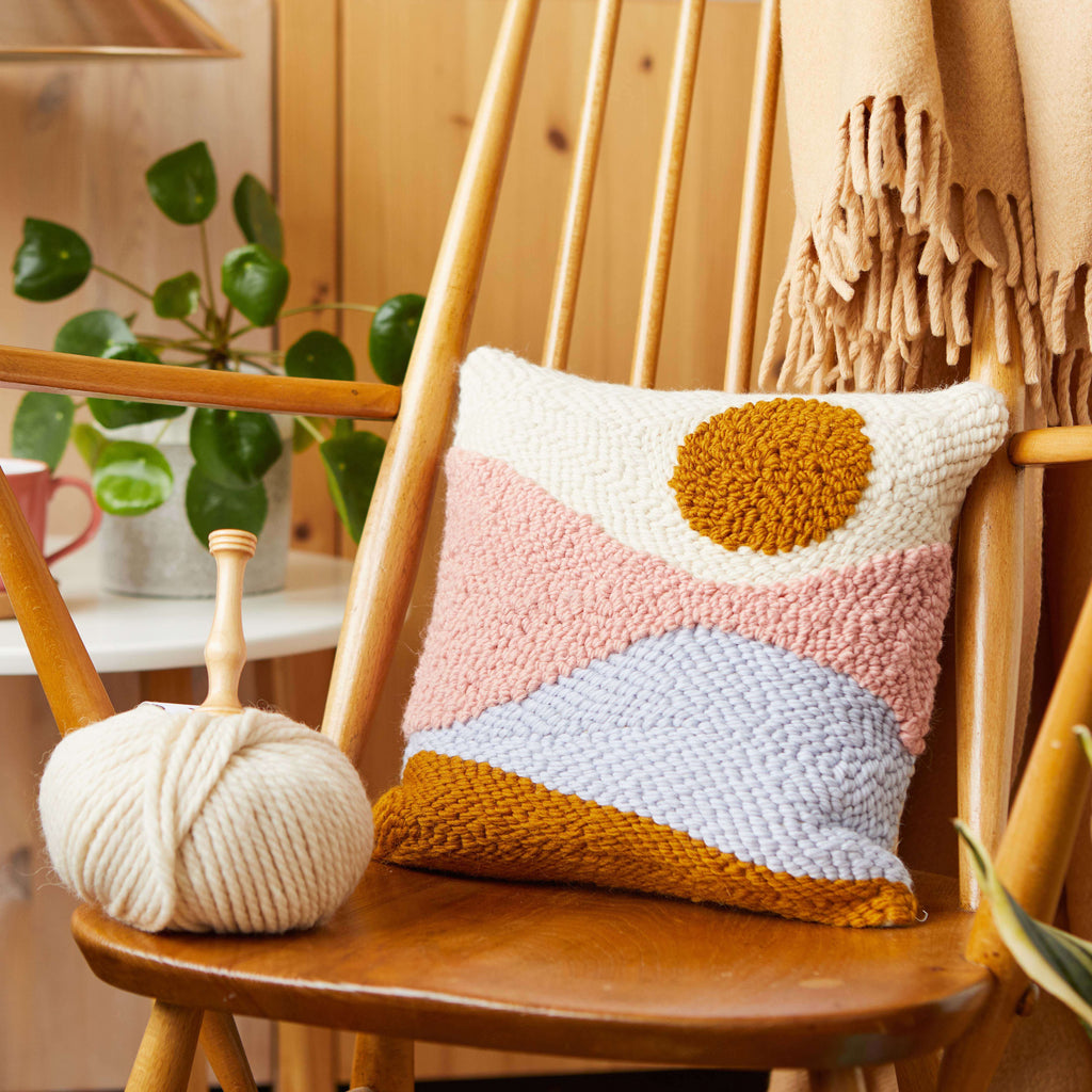 Punch needle cushion with sunset pattern made with British Wool